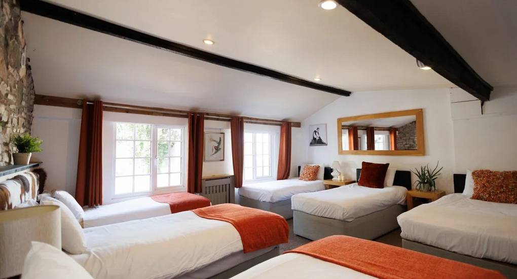 The largest bedroom in Autumn Cottage Bristol with six beds
