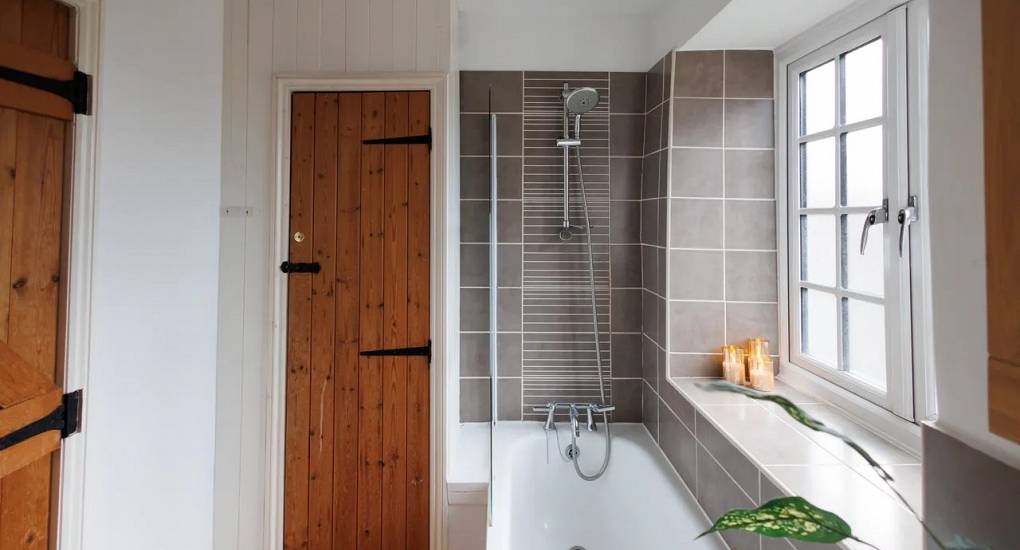 Large bathroom with shower over bath at Autumn Cottage Bristol