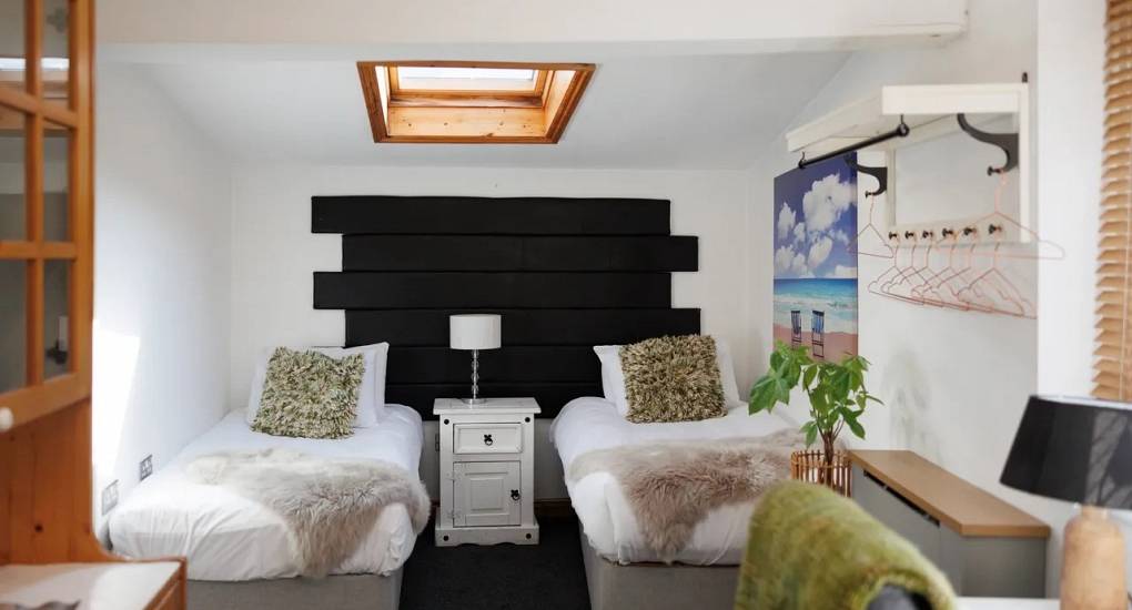 Large twin room with feature head board at Autumn Cottage Bristol