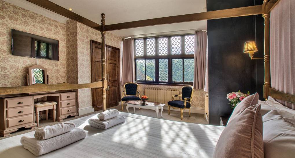 King size bed with TV on wall