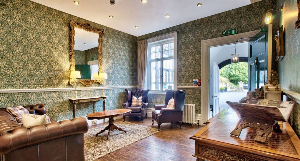 Snug room with green feature wall paper