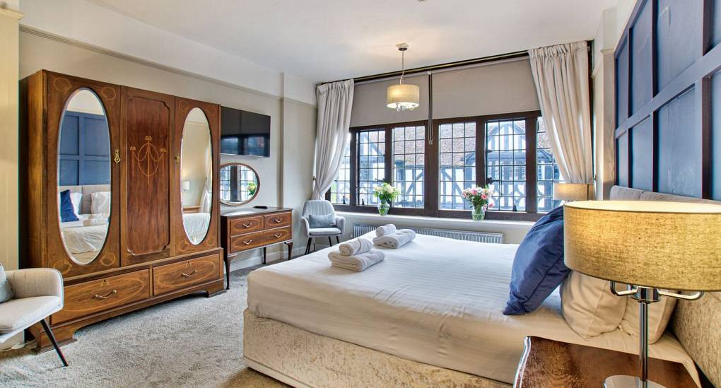 Double bedroom with large wooden wardrobe