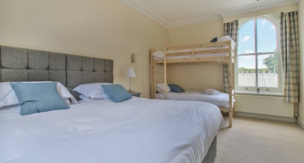 Large bedroom with two double beds and a bunk bed