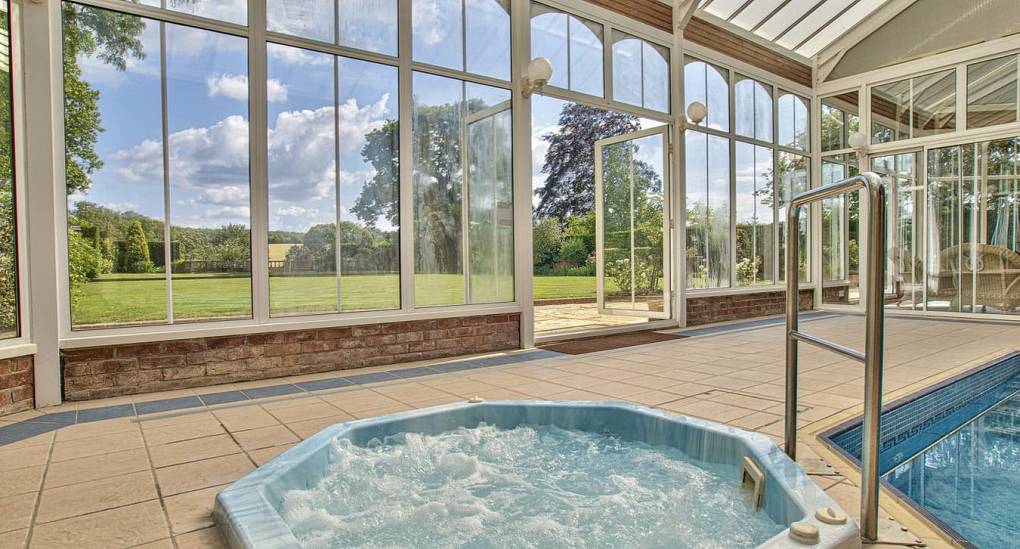 Hot tub next to the swimming pool