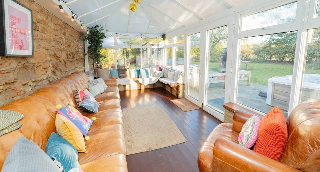 Conservatory with large sofa and lots of light 