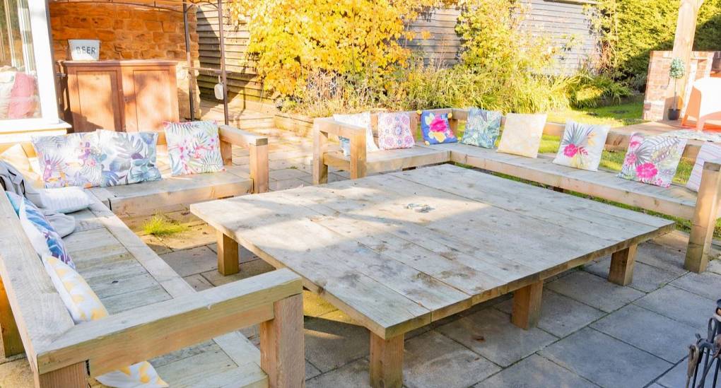 Very big outside dining table and bench seating 