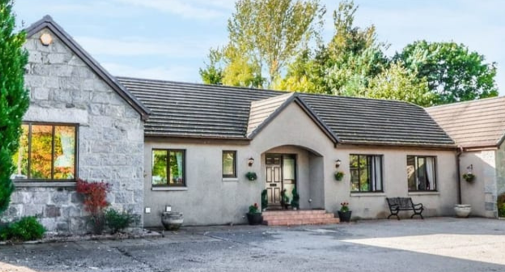 Exterior view of Scottish Escape, a luxury Aberdeen hen party house featuring a private hot tub and countryside grounds.