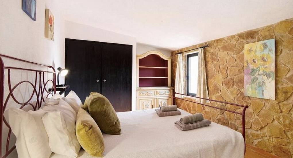 double bedroom with stone walls