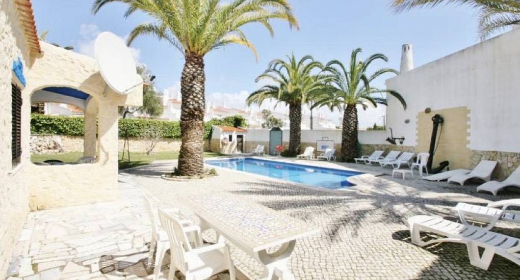 Outdoor space with pool and sun loungers 