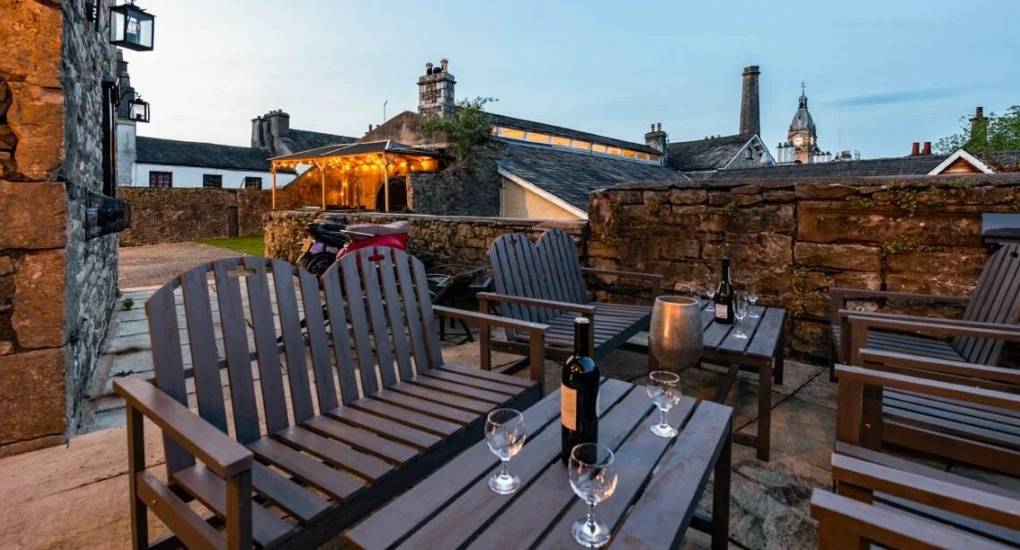 Large seating area on the upper floor overlooking the old stone style cottages 