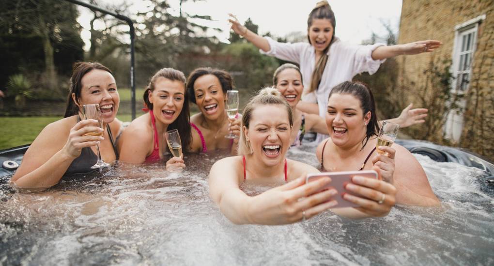 Hens enjoying hot tub in hen party house