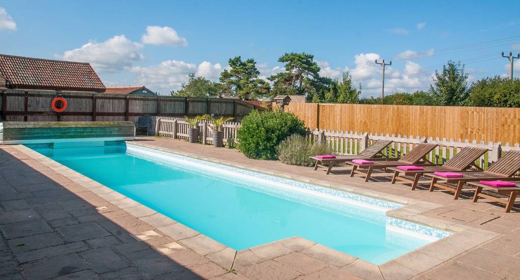 Another view of the heated swimming pool with the cottage in the background