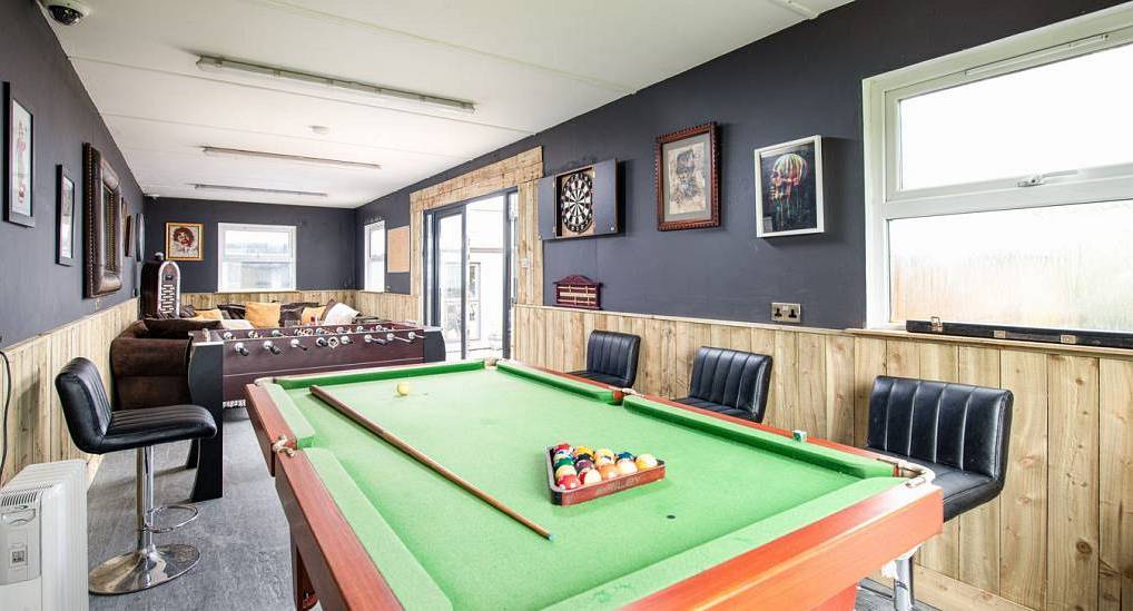 The games room with pool table and foosball at Shabby Shack, rustic hen party barns near Bath sleeping 16.