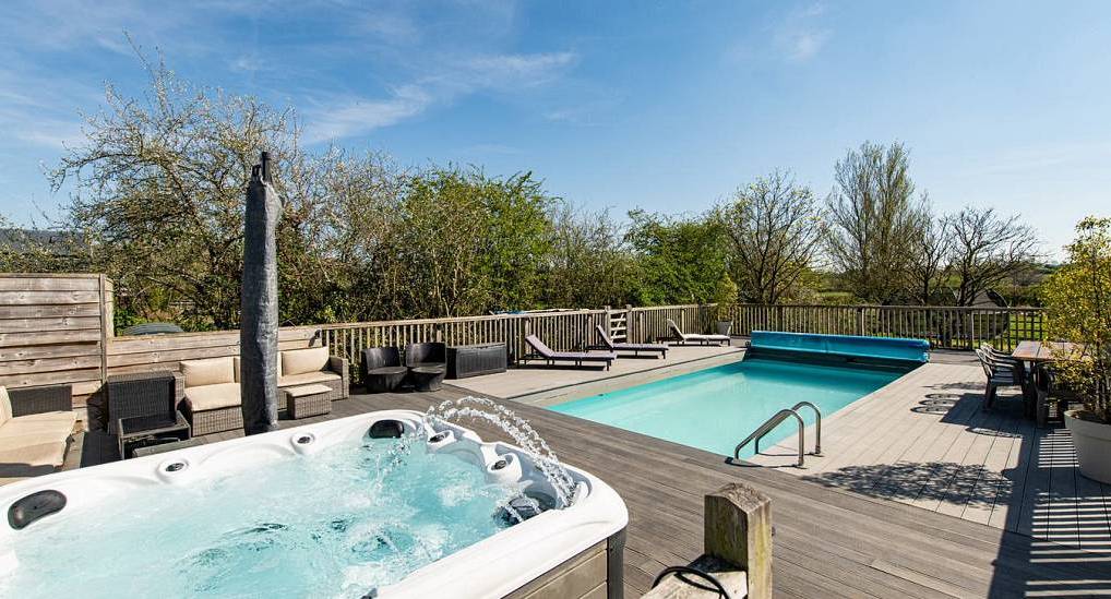 The sun deck swimming pool and hydrotherapy hot tub at The Chateau, a luxury Bath hen party house sleeping 24.