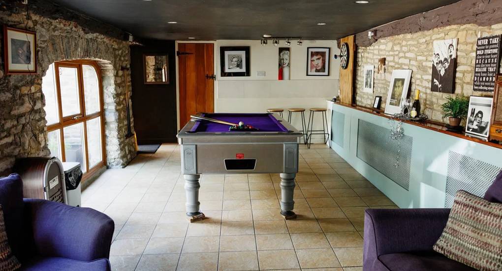 The games room with pool table and stone wall arches at The Games Pad, fun Bath hen accommodation near the city.