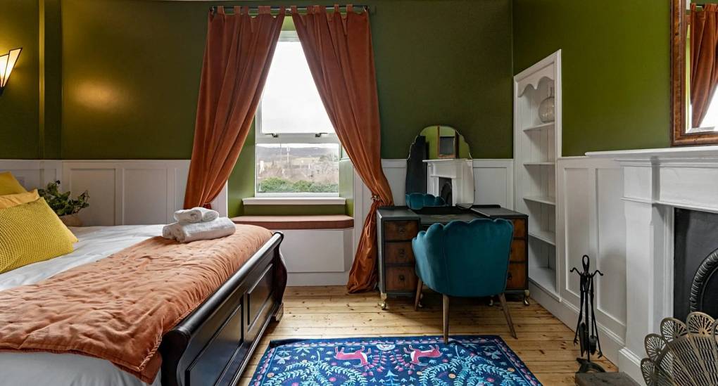 Bedroom one at Highland House in Kingussie: A Victorian-style bedroom with a large double bed for a Highland hen do.