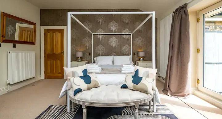 The master bedroom showing a four post bed