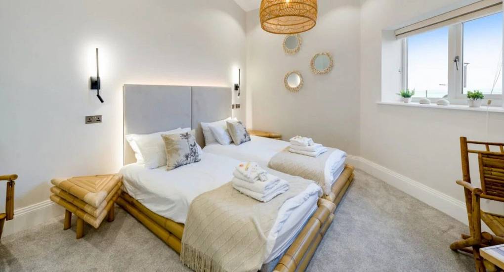 Cream bedroom with a king size bed ready for guests