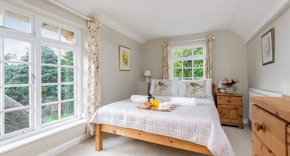 Bedroom with double bed in the Secret Gardens New Forest party house