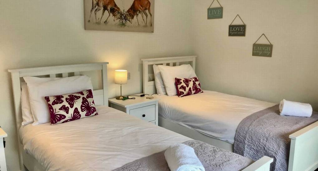 Bedroom with two double beds at the Forest Tree House 