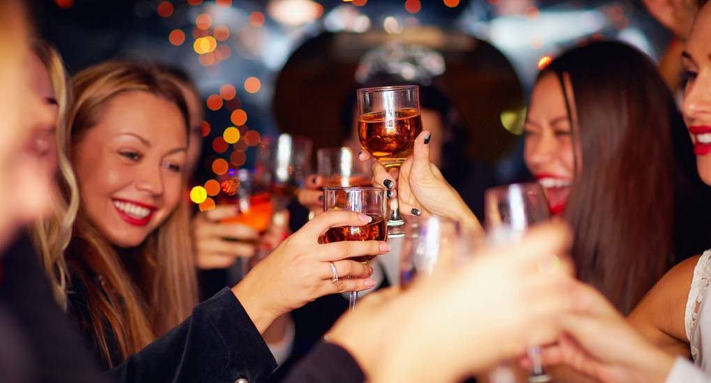 Group of hens enjoying drinks in an upmarket bar, toasting to the occasion