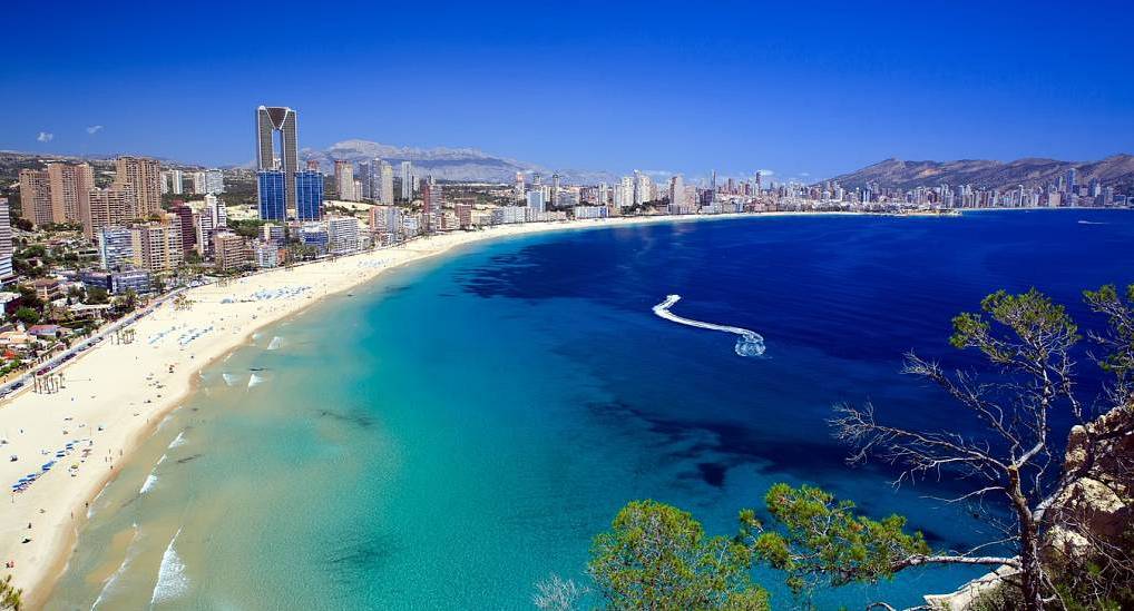 Panoramic aerial view of Benidorm crescent beach bay and skyscraper skyline, ideal destination for a Benidorm hen do.