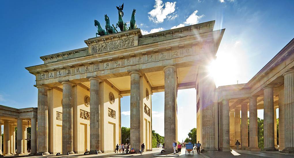 Sunlit Brandenburg Gate neoclassical columns with Quadriga statue on top, iconic landmark for a Berlin hen do.