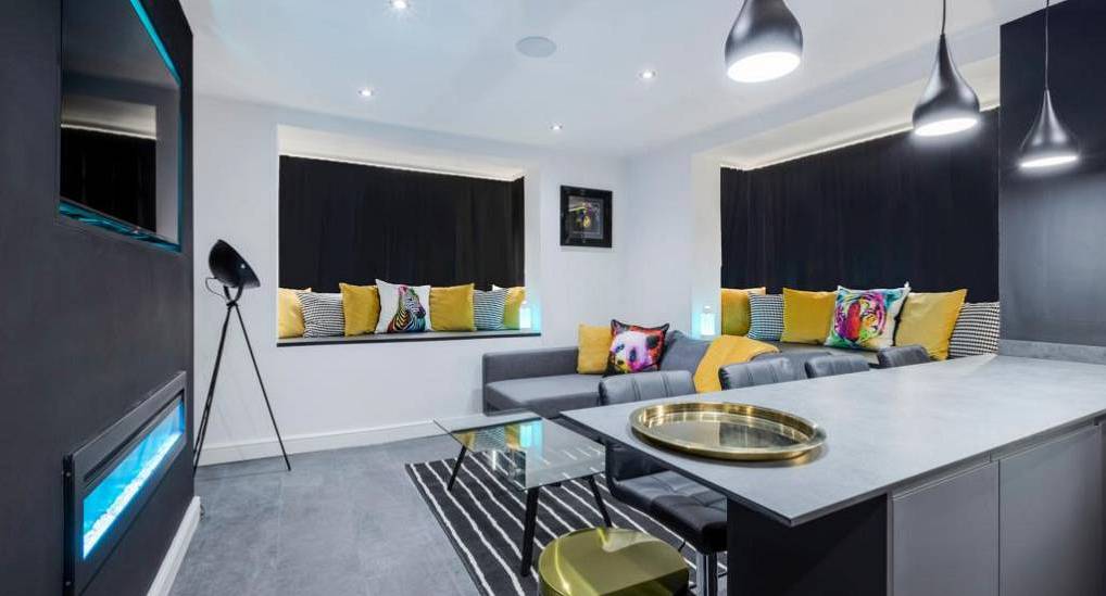 Modern open-plan living room and lounge at Shore Suites, value seaside Blackpool hen party accommodation.