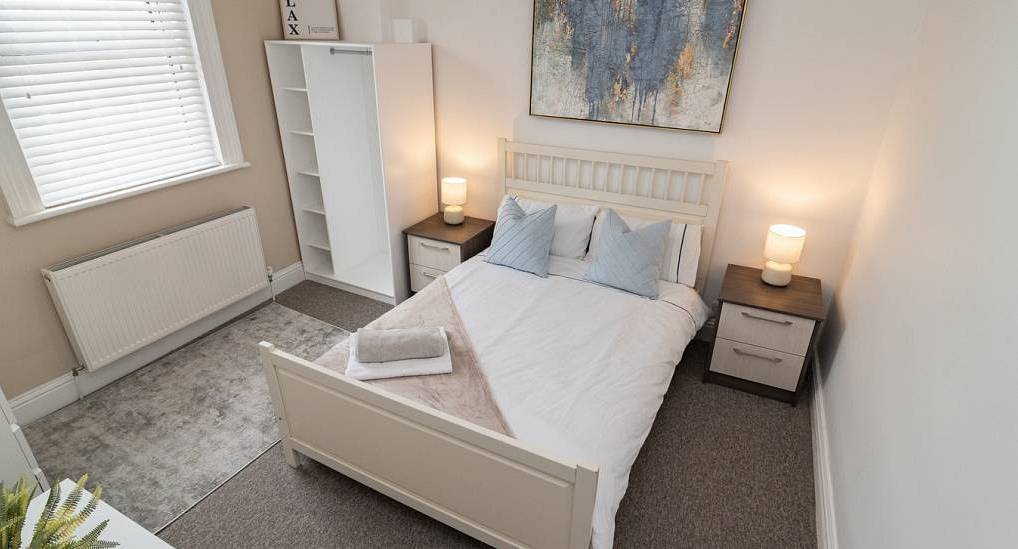 Bright modern bedroom with double bed at BH2, central Bournemouth hen party apartments for large groups.