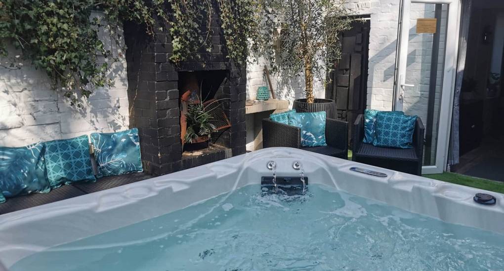 7-seater spa and social seating area in the private courtyard of the Bournemouth Hot Tub Garden hen party house.