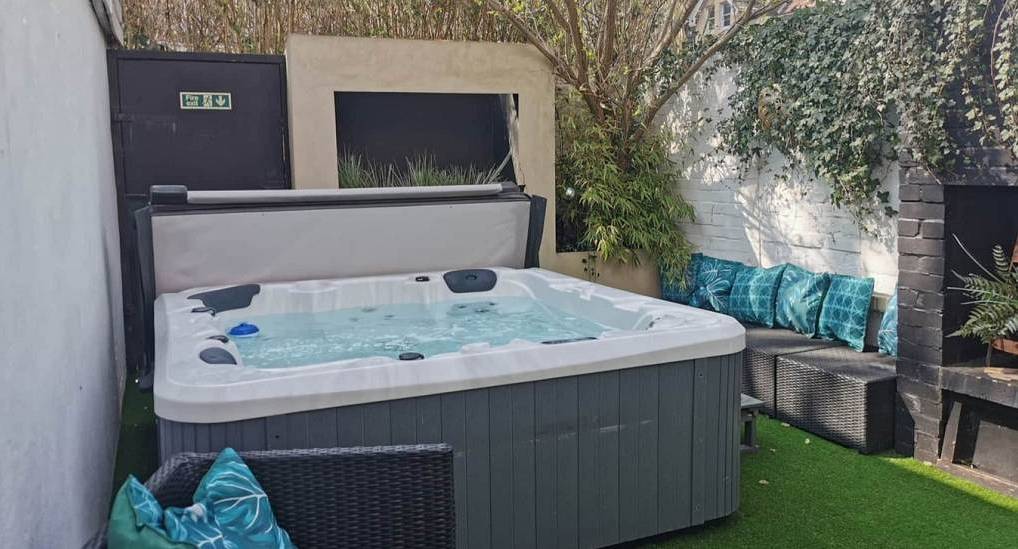Private courtyard garden with hot tub at Hot Tub Garden, a central Bournemouth hen party house sleeping 16.
