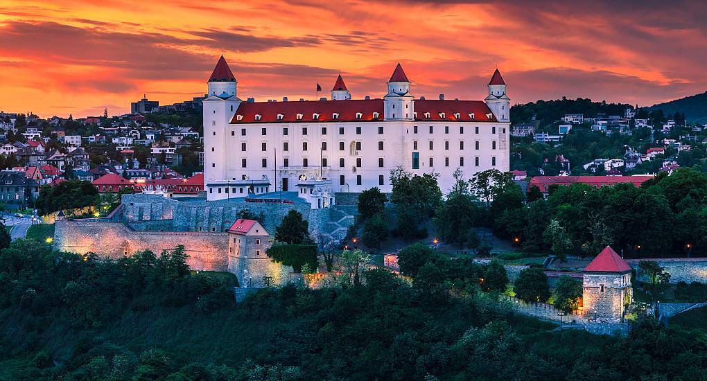 Bratislava Castle glowing under dramatic sunset skies on a hilltop, setting an impressive scene for a Bratislava stag do.