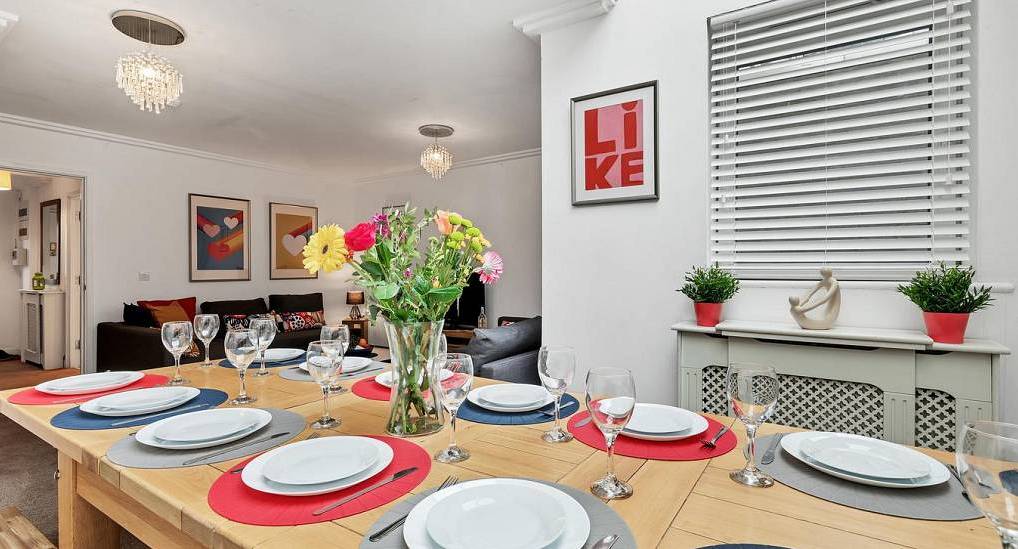 Spacious dining table laid for group celebrations at CBH House, a North Laine Brighton hen party house.