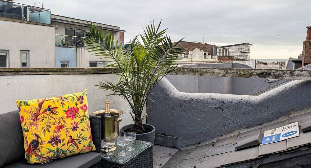 Private roof terrace with lounge seating and champagne at Colour House, luxury Regency hen house in The Lanes.