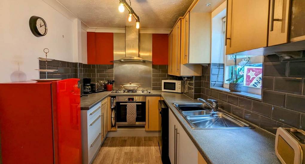 Kitchen long view with red fridge