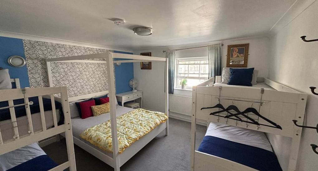 Large bedroom with bunk beds decorated blue