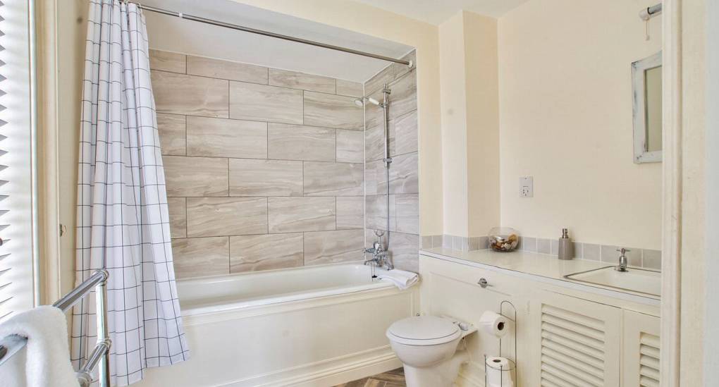 Family bathroom with shower over bath