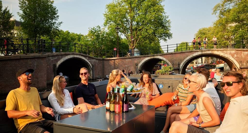 Group of friends on a canal boat bar tour