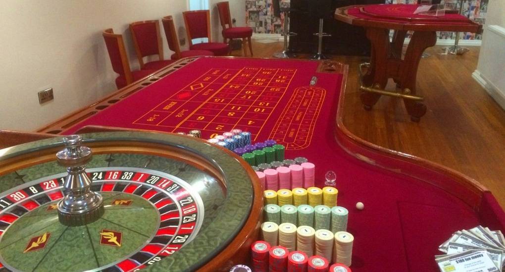 Casino room with Roulette Wheel and Card Table