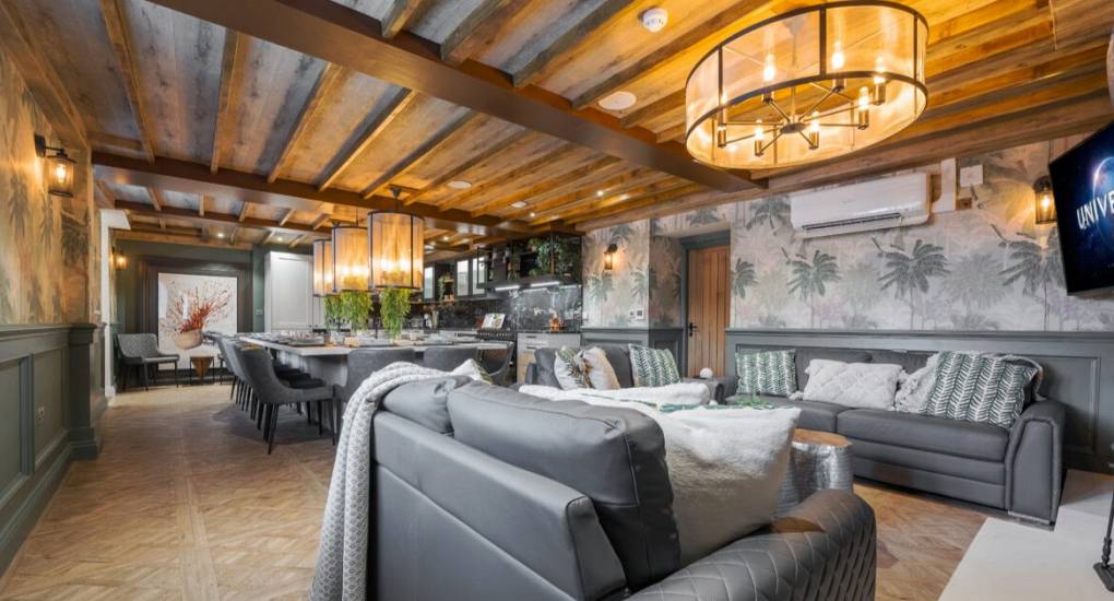 Lounge area with the open plan kitchen diner in the background