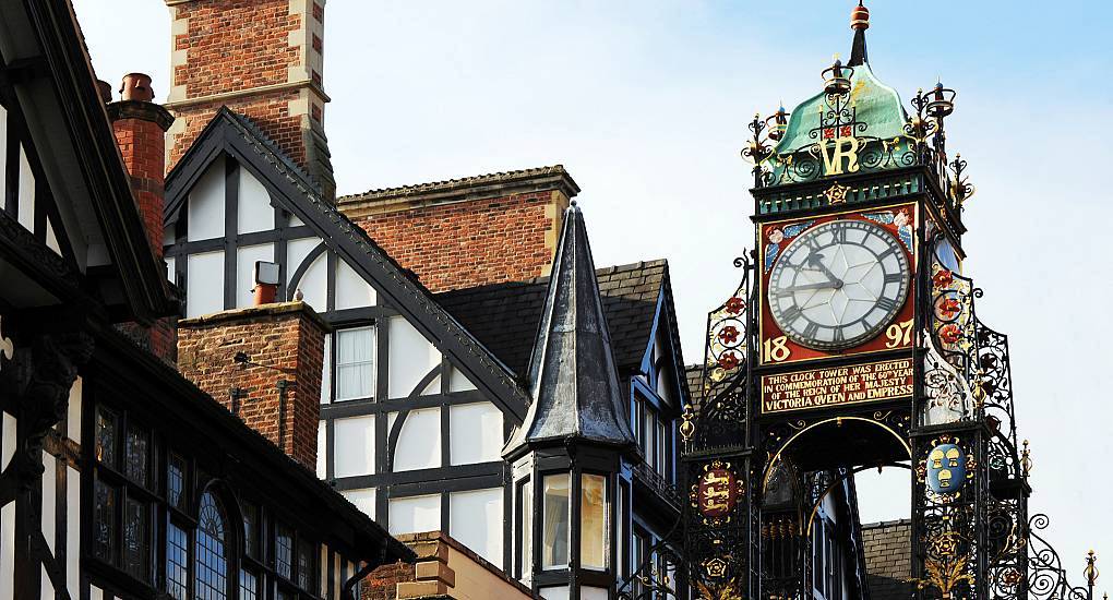 Victorian Eastgate Clock beside traditional half-timbered Tudor buildings, historic setting for a Chester hen do.