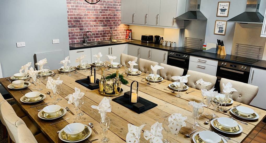 Large wooden dining table set for formal group meals at Rural Chester Valley, detached country hen house near Chester.