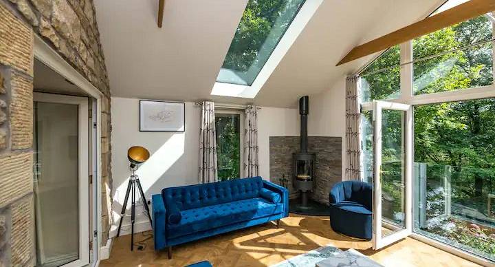 conservatory area with open doors looking out at the trees