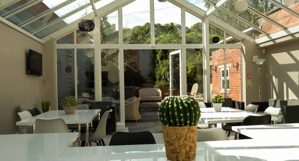 Large conservatory area with seating at the Swan Hen Do accommodation