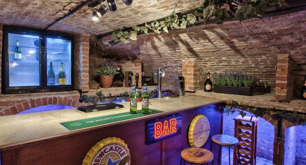 A close-up of the private bar area at Country Fortress, a luxury Newcastle hen party house with themed social spaces for large groups.