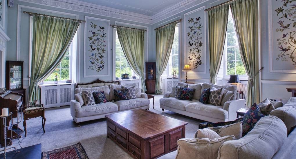 A large, stylish communal lounge at Country Fortress, a luxury Newcastle hen party house with plenty of seating for large groups.