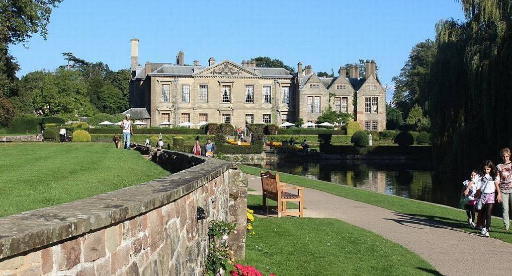 Coombe Abbey Hotel manor house and formal gardens beside ornamental lake, scenic backdrop for a Coventry stag do.