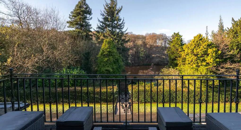 View from the balcony overlooking well manicured gardens and foliage