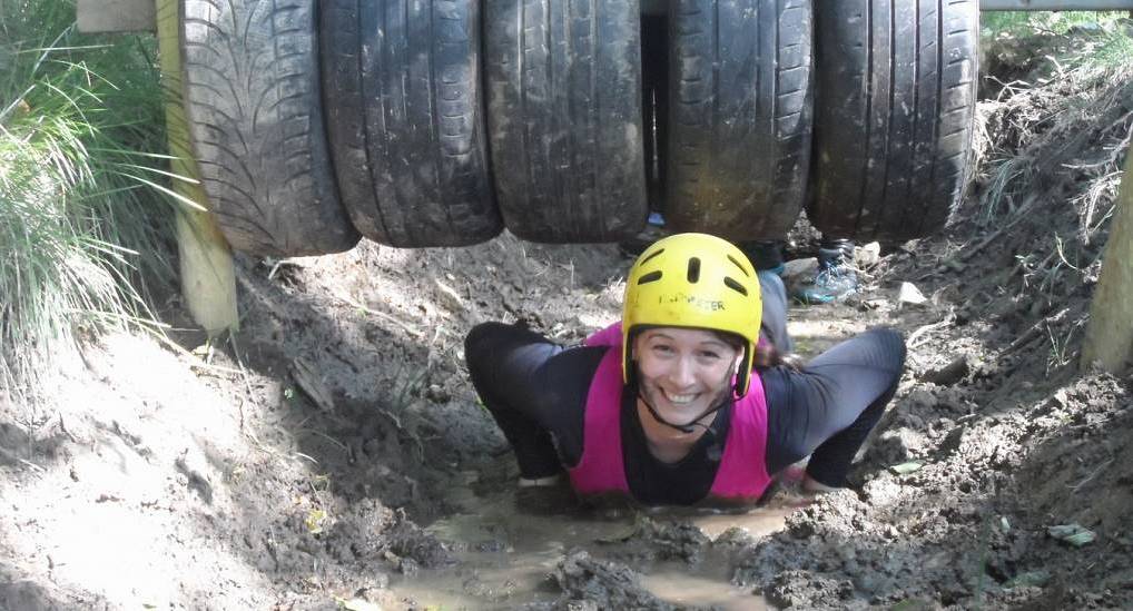 Member of hen party gets through the tyre obstacle
