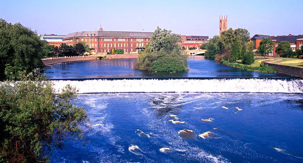 River Derwent weir and Derby Cathedral tower on the skyline, peaceful setting for a Derby hen do.